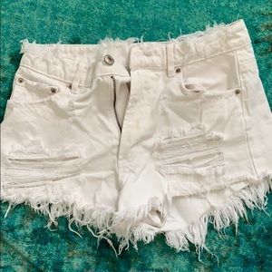 Distressed white denim shorts